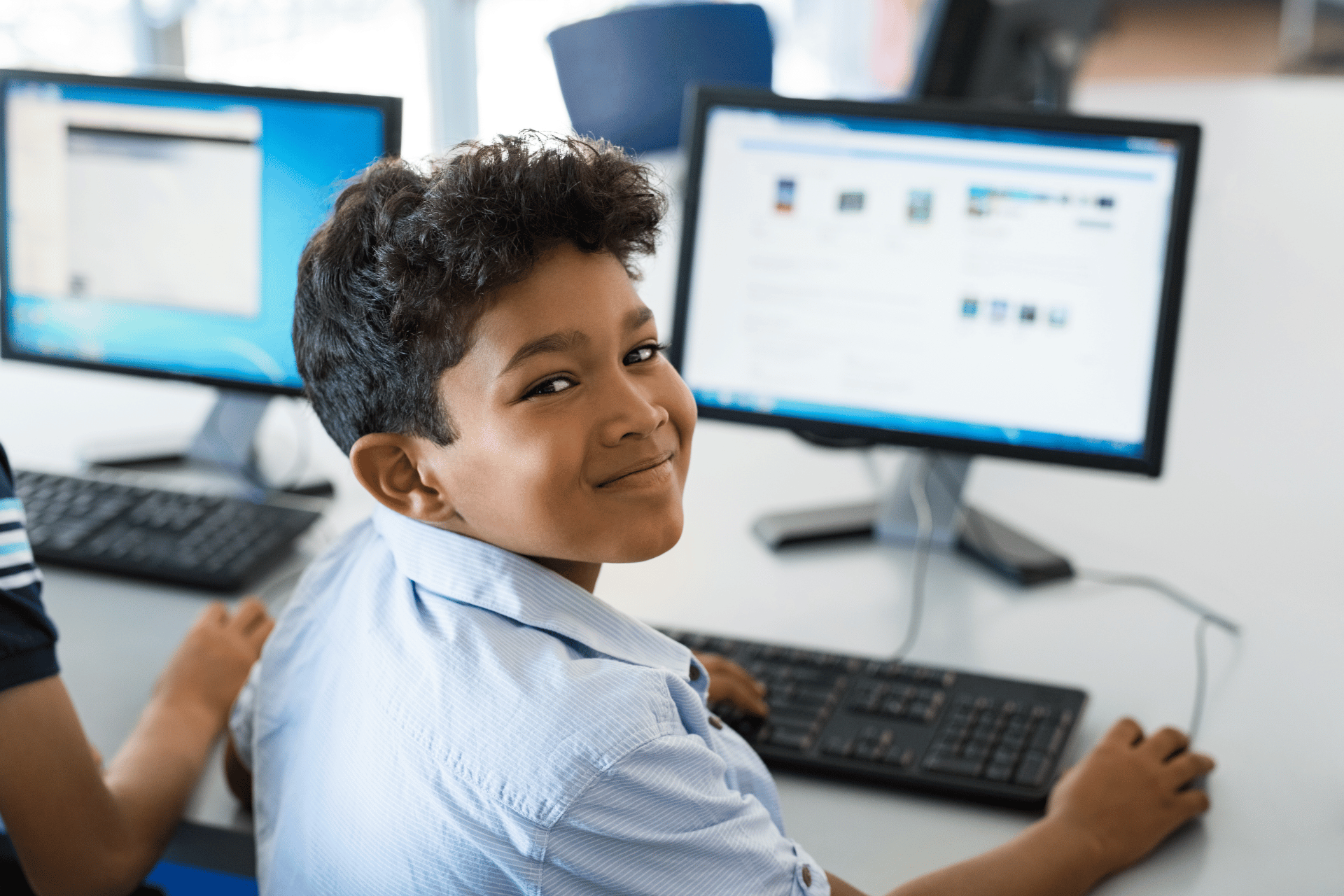 kid using a computer screen and keyboard