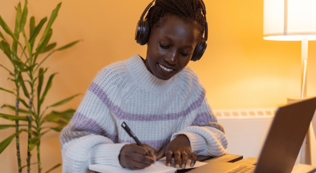 remote learning lady , laptop , pen & exercise book
