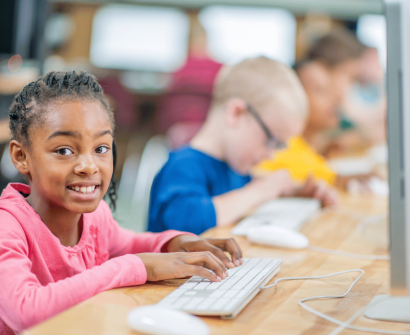 multi racial class , african kid typing the keyboard , computer screen