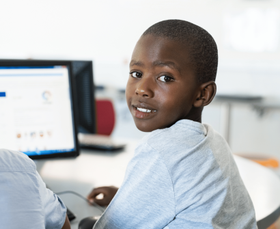 black kids , in front of the computer screen